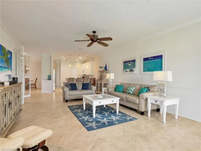 Living Area with Tile Flooring on the Diagonal, Crown Molding, Chair Rails, Ceiling Fan, Entrance to Den/Flex Room, Kitchen, & Dining Area