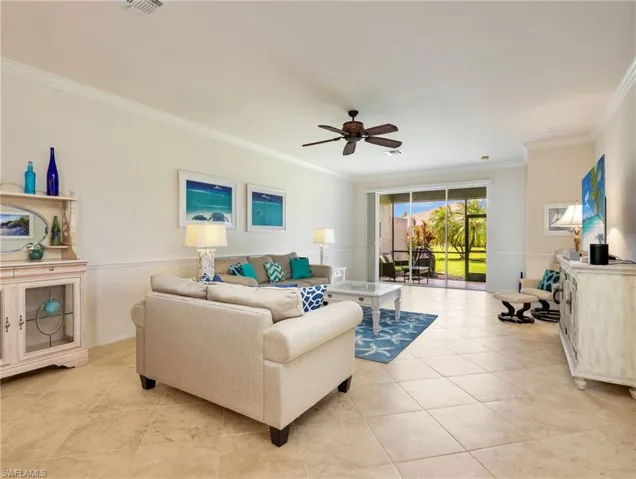 Living Room with Tile Floors on the Diagonal, Crown Molding, Chair Rail, Ceiling Fan & Sliders with Verticell Shades Leading to the Screened-In Lanai