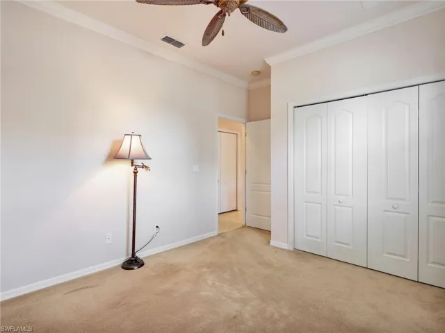 Second Bedroom with Crown Molding, Ceiling Fan, Closet with California Closets Built-In Organizers & Closet in Hallway for Extra Storage