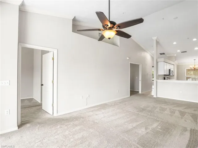 Great Room With Vaulted Ceilings and Doorway To Primary Bedroom