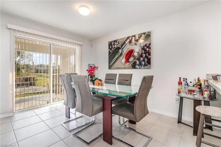 Dining area featuring light tile patterned floors and baseboards