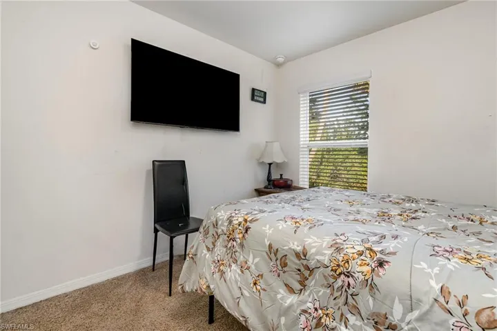 Carpeted bedroom featuring baseboards