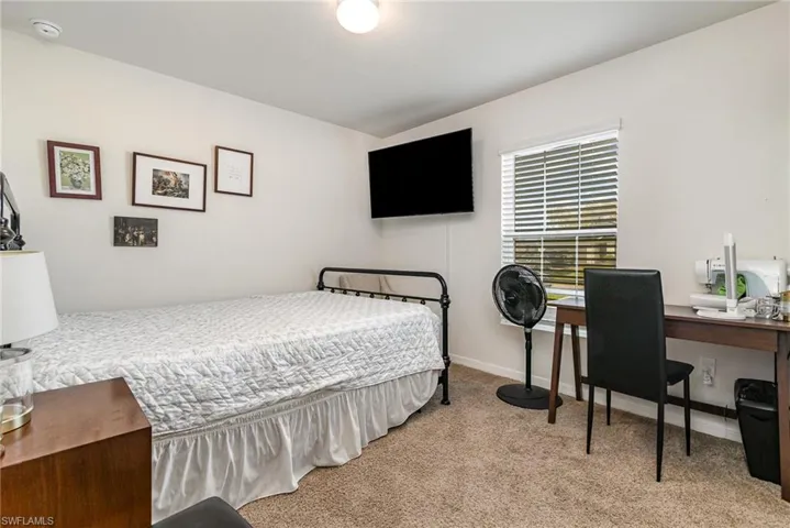 Bedroom featuring carpet floors and baseboards