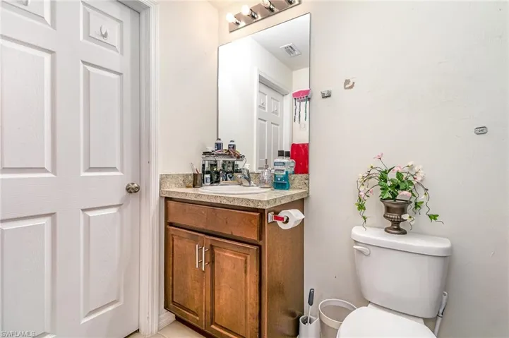 Bathroom featuring visible vents, vanity, and toilet