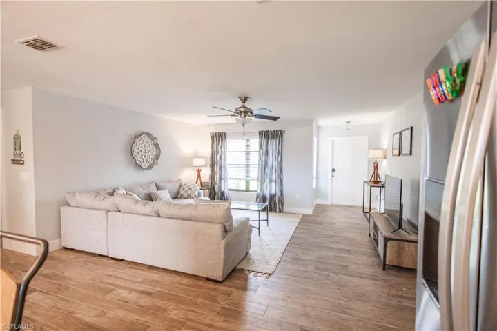 Living area featuring ceiling fan and light wood-type flooring