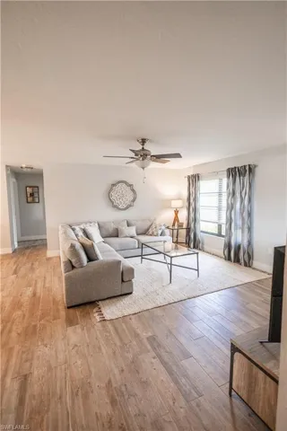 Living area featuring a ceiling fan and light wood finished floors