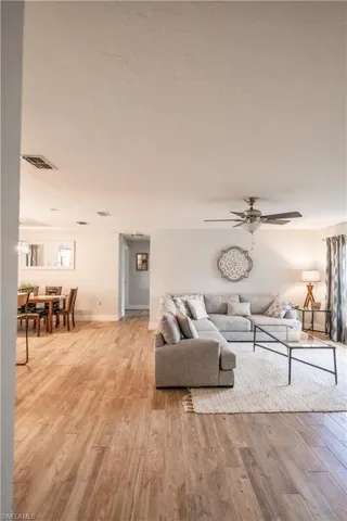Living area featuring light wood-style flooring and a ceiling fan