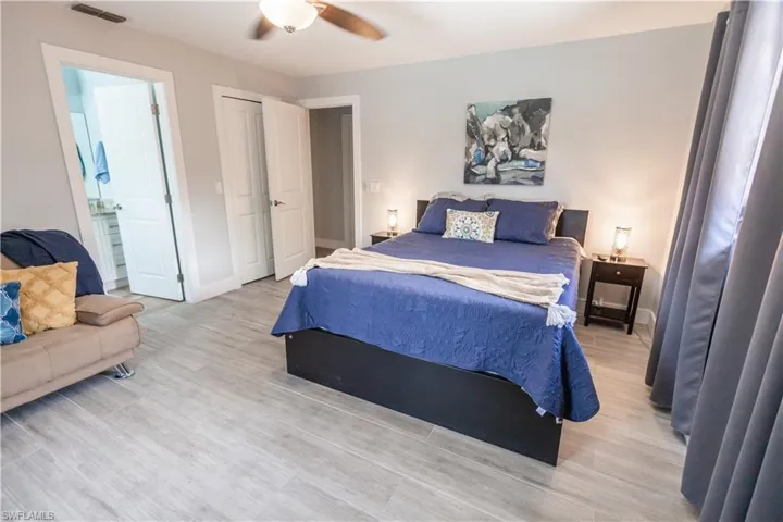 Bedroom with light wood-type flooring and a ceiling fan
