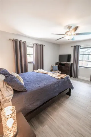 Bedroom featuring wood finished floors and a ceiling fan