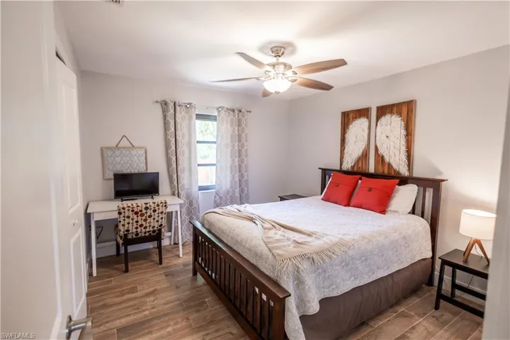 Bedroom with wood tiled floors and ceiling fan