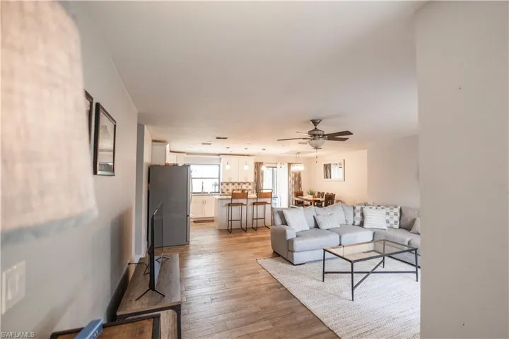 Living area featuring light wood-type flooring and ceiling fan
