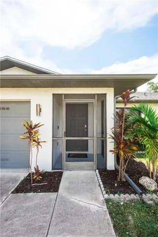 Entrance to property with stucco siding