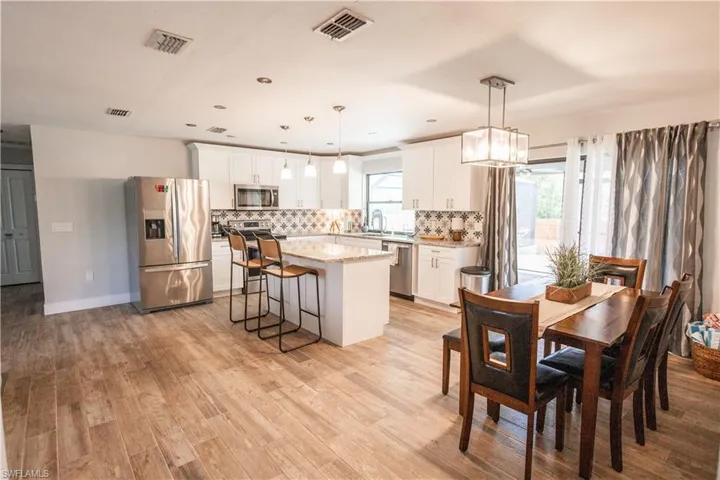 Dining room featuring light wood-type flooring and a chandelier