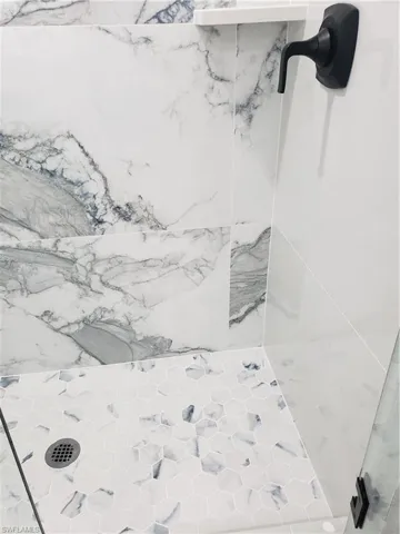 Interior details of guest bathroom shower.  Custom glass and door entry