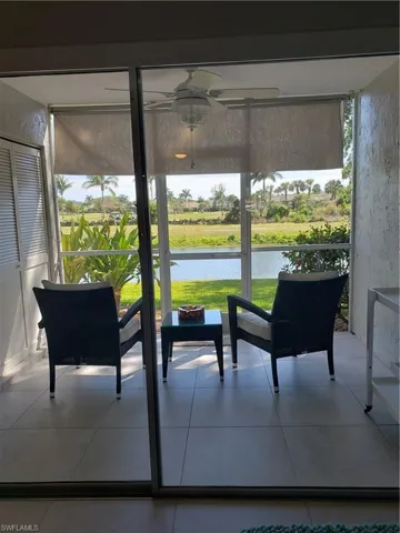 Sunroom / solarium with a water view and ceiling fan