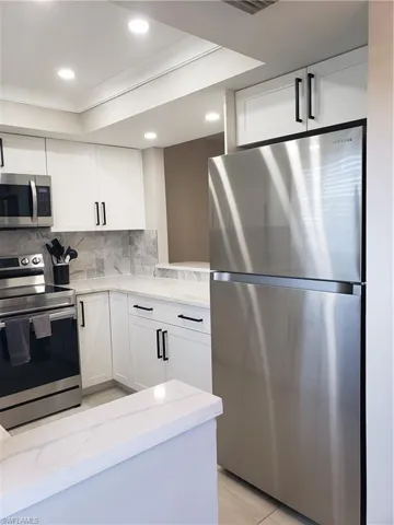 Kitchen has trayed ceiling with extra lighting