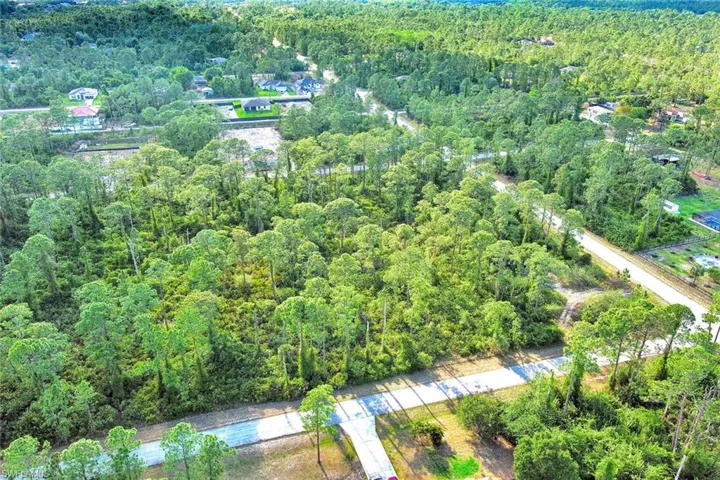 Aerial overview of property's location featuring a heavily wooded area