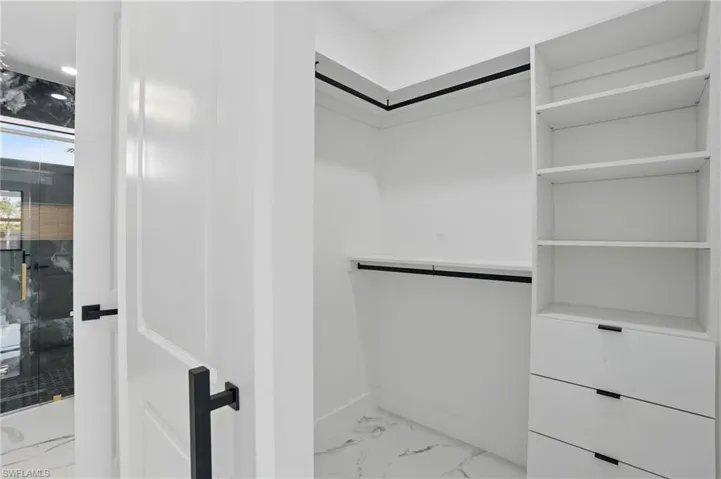 Spacious closet with marble look tile flooring