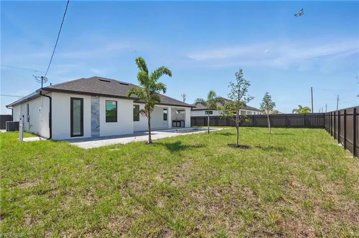 Back of house with a patio, stucco siding, and central air condition unit