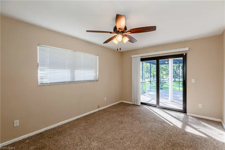 Carpeted spare room with ceiling fan