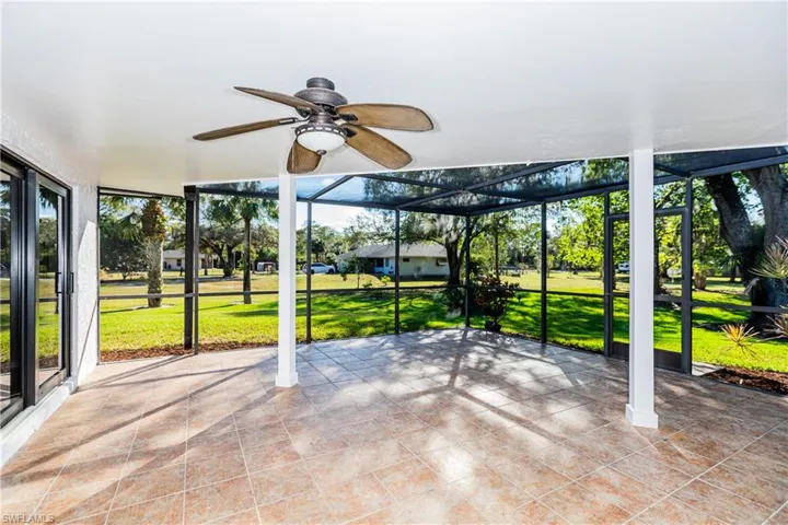 Unfurnished sunroom featuring ceiling fan