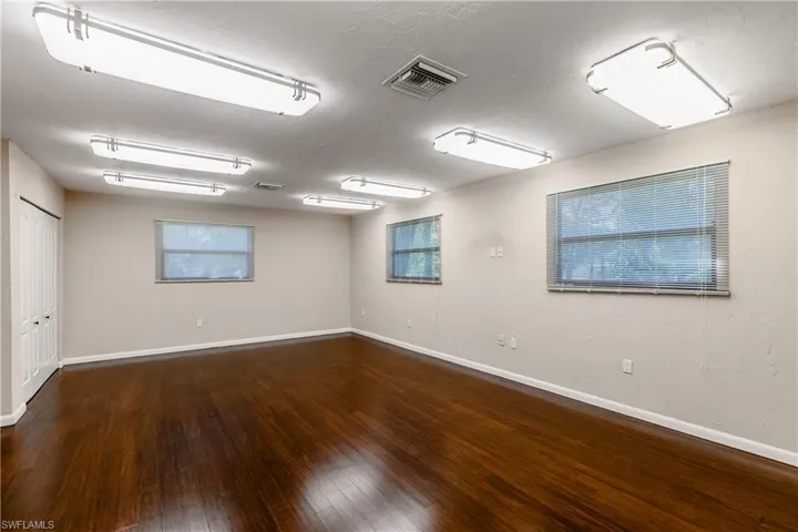 Empty room featuring dark wood-type flooring