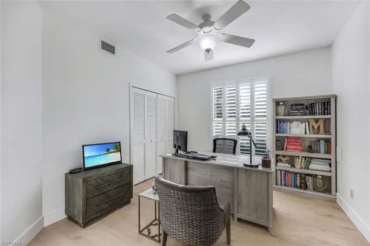 Office area featuring light hardwood / wood-style flooring and ceiling fan