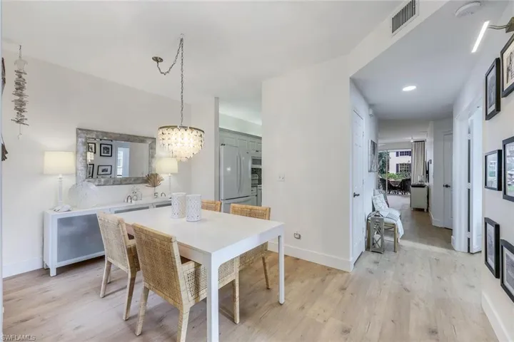 Dining space with a chandelier and light hardwood / wood-style flooring