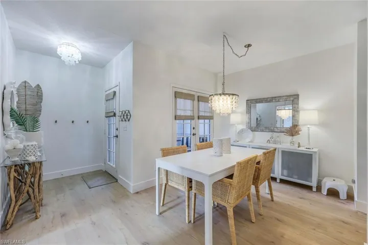 Dining room featuring a notable chandelier and light wood-type flooring