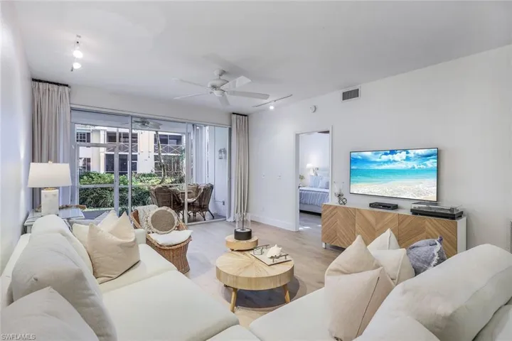 Living room with light wood-type flooring and ceiling fan