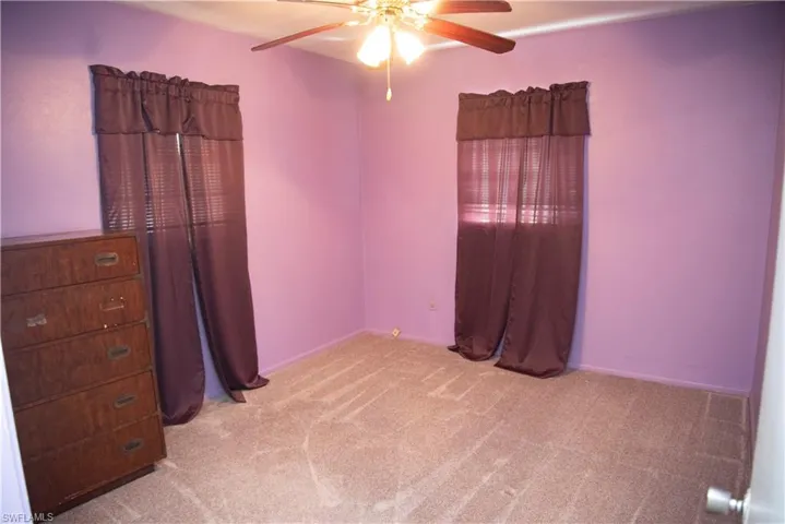 Bedroom with light carpet and ceiling fan