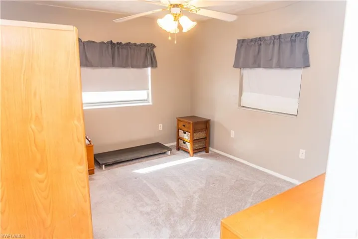 Spare room with ceiling fan and carpet