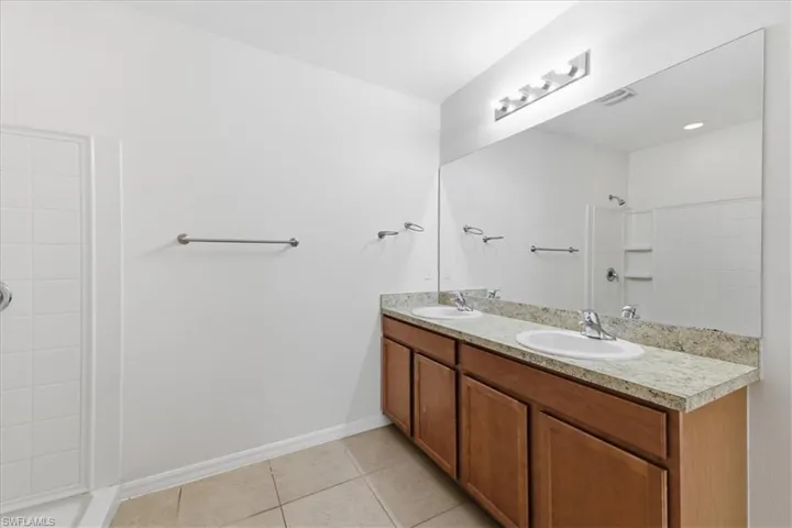 Dual vanity with light-tone countertops and under-mount sinks