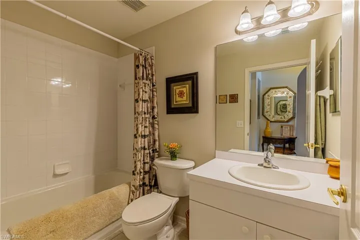 Full bathroom with vanity, toilet, and shower / tub combo with curtain