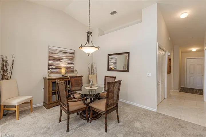Tiled dining area right off the kitchen with vaulted ceiling