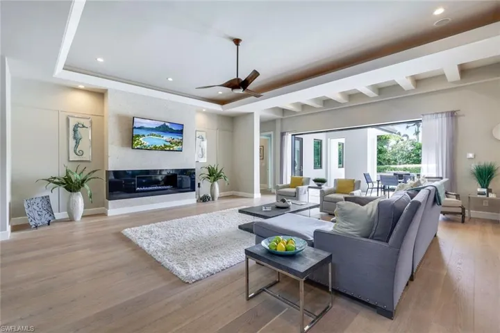 Living area with recessed lighting, a ceiling fan, and wood finished floors
