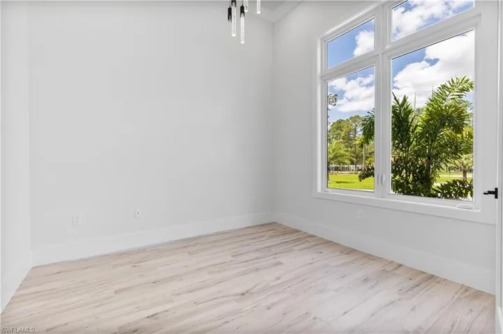 Spare room featuring wood finished floors and baseboards