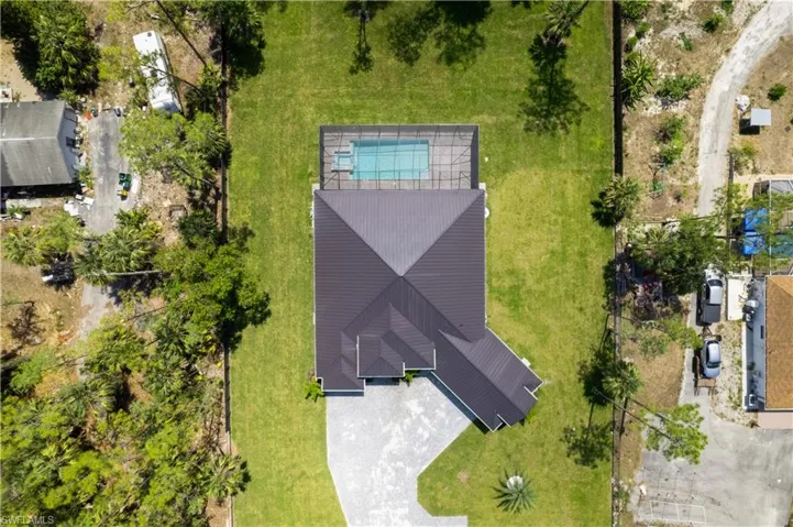 Aerial view of property and surrounding area featuring a pool area