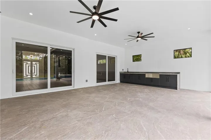 View of patio with ceiling fan and an outdoor kitchen