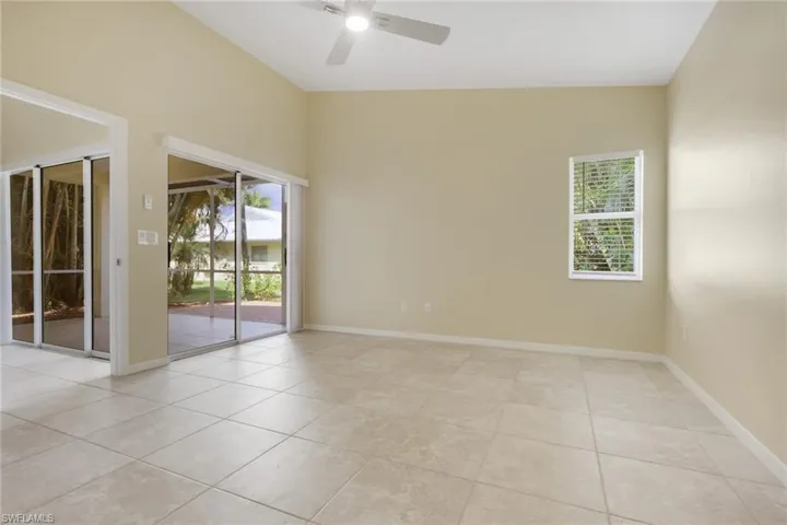 Spacious interior featuring vaulted ceilings, neutral wall tones, and large format floor tiles