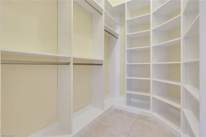 Custom-designed closet system featuring extensive shelving and multiple hanging rods