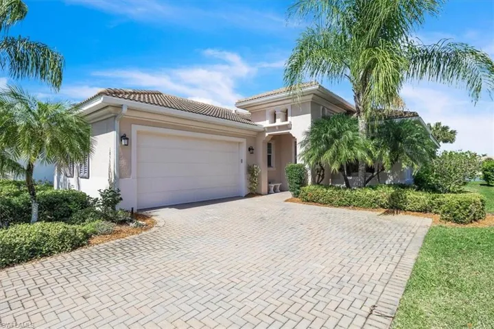Mediterranean / spanish-style home with an attached garage, stucco siding, decorative driveway, and a tile roof