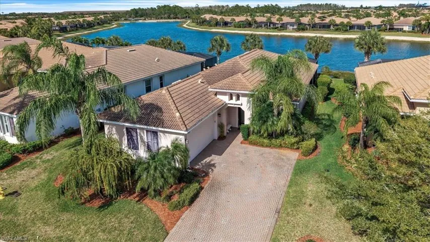 Aerial perspective of suburban area with a nearby body of water