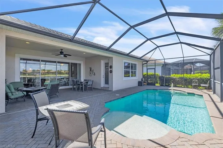 Swimming pool featuring a sunroom, outdoor dining area, a patio area, and a lanai