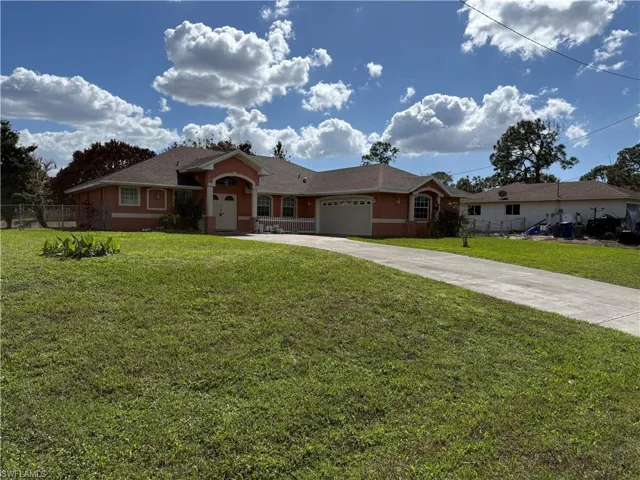 Ranch-style house with an attached garage, driveway, and stucco siding