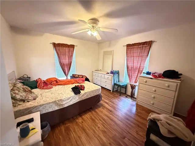 Bedroom featuring dark wood-style floors and a ceiling fan