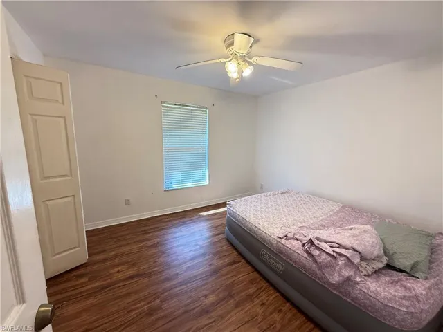 Bedroom featuring dark wood-type flooring and a ceiling fan