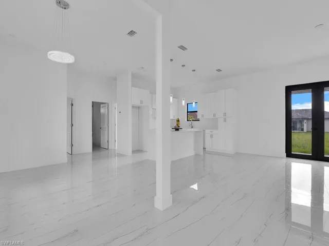 Empty room with light tile flooring