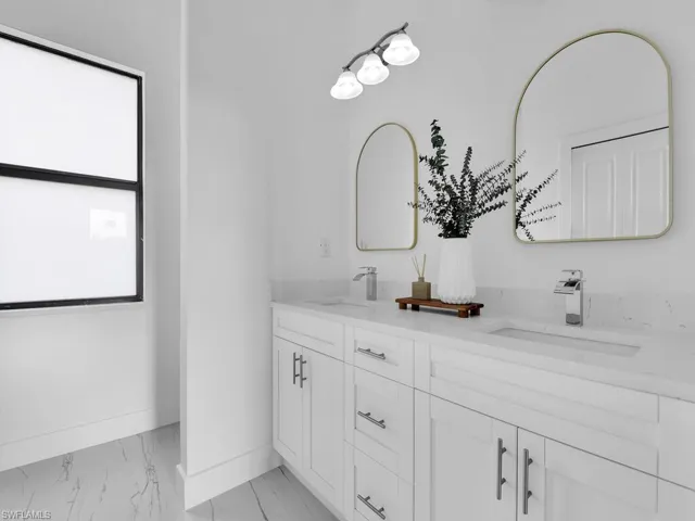 Bathroom with double vanity and tile floors