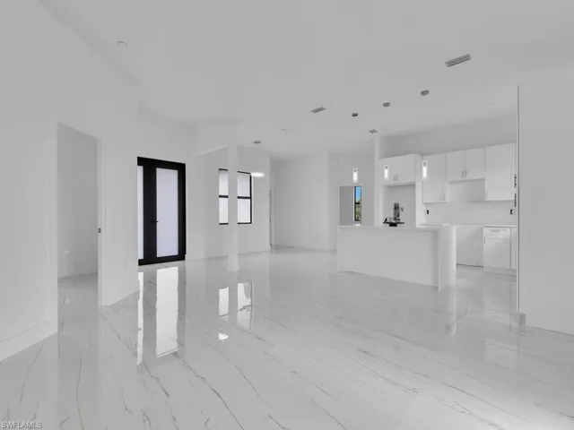 Unfurnished living room with light tile floors